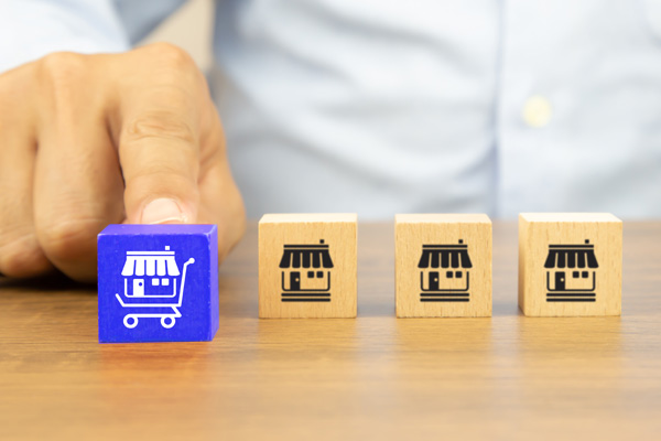 Person pushing cube with retail icon forward