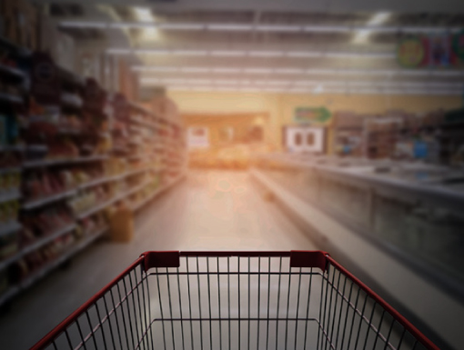 Empty grocery cart in dark aisle way